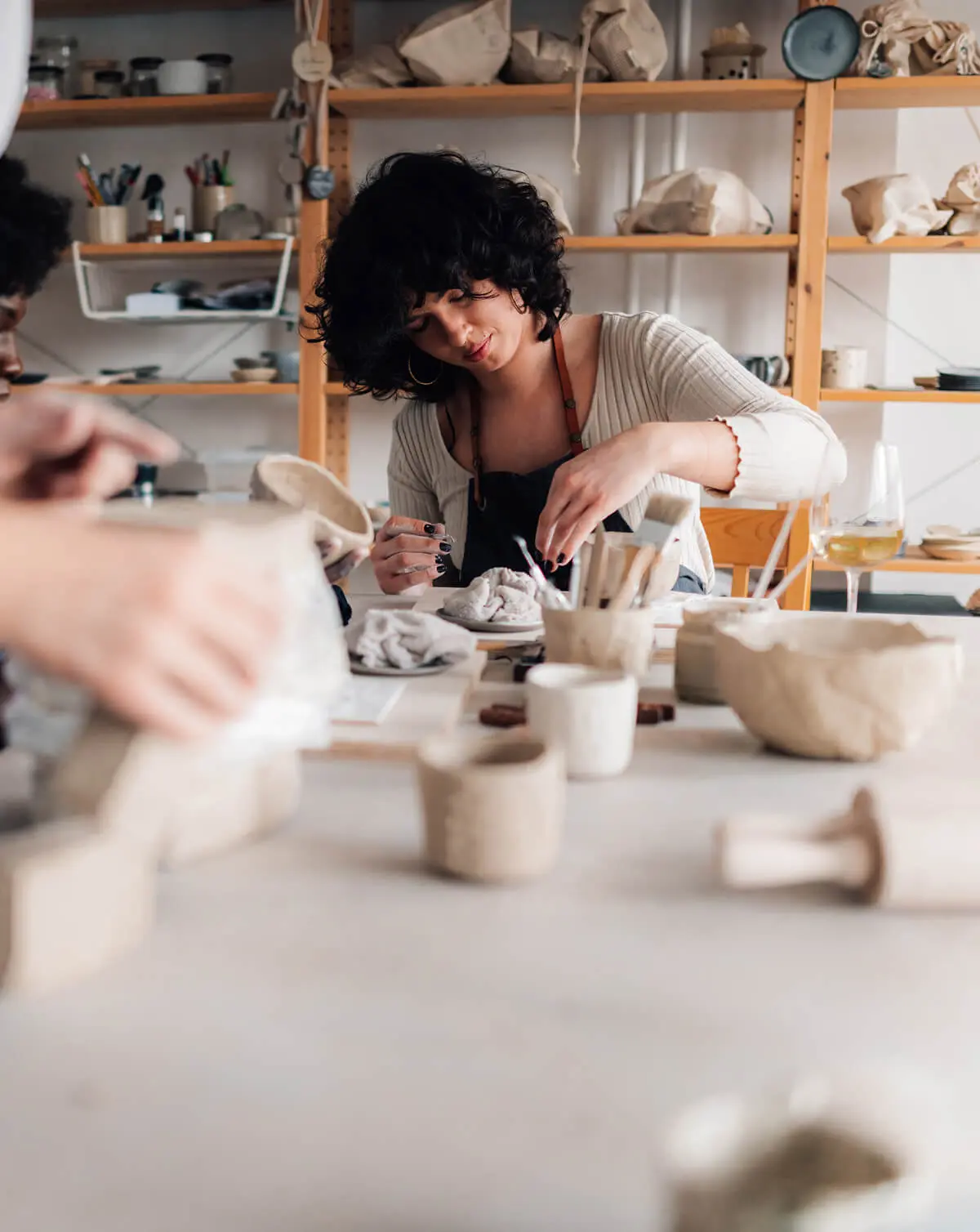 Woman crafting pottery in studio