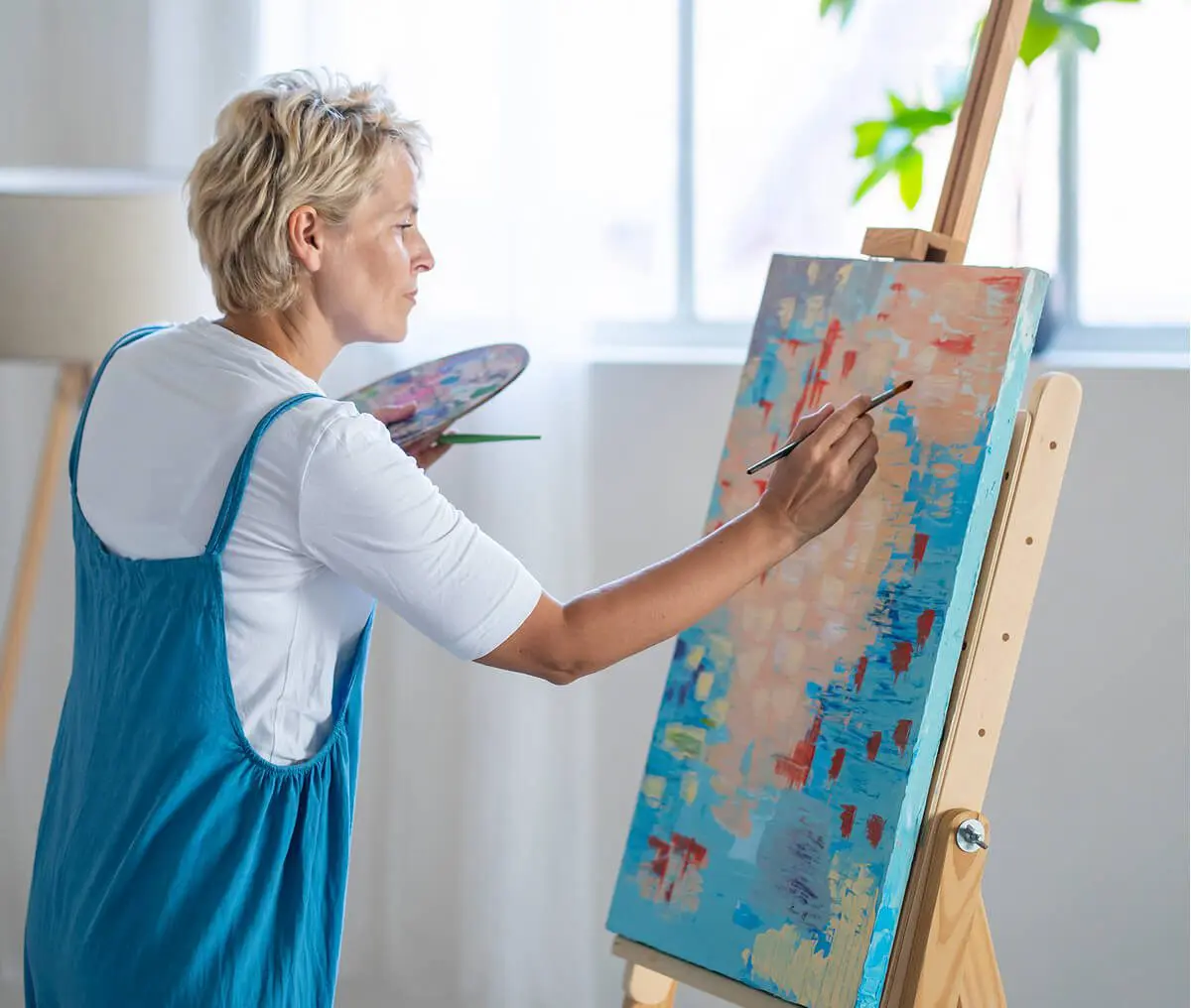 Artist creating colorful abstract painting