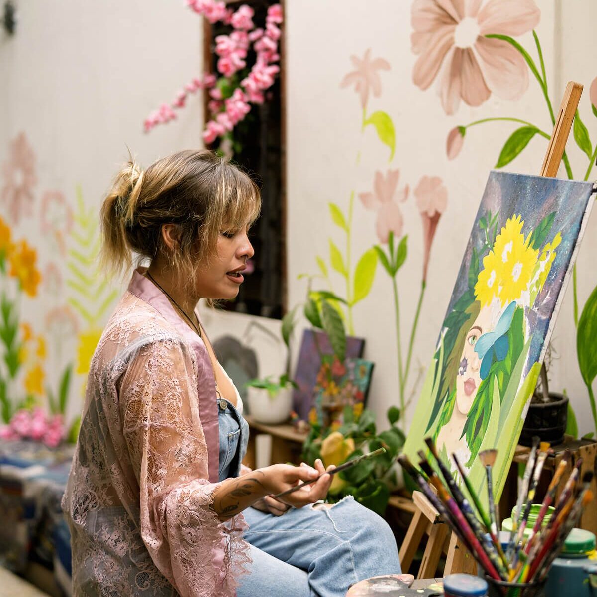 Painter working on colorful floral piece